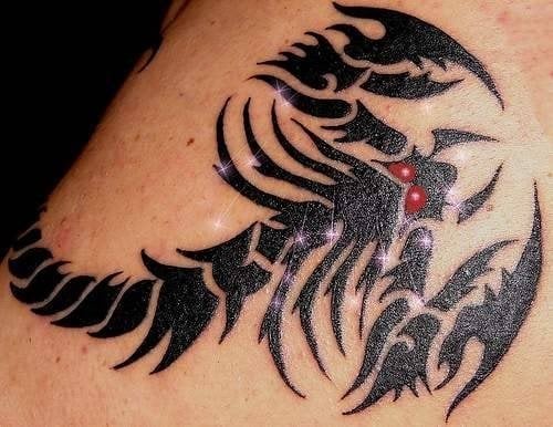 Tatuaje de los signos del zodiaco representando a escorpio y en el que la originalidad de este tattoo reside en los dos puntos rojos que se han tatuado y que hacen las veces de ojos