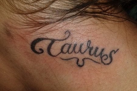 Tatuaje en el cuello con la palabra Taurus, el signo zodiacal para los nacidos entre finales de abril y de mayo, que simboliza la consolidación y cuyo símbolo representa la cabeza de un toro con astas circulando a su alrededor